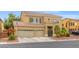 Inviting two-story home with a three-car garage, mature landscaping, and charming curb appeal at 8929 Monte Oro Dr, Las Vegas, NV 89131
