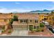 Beautiful two-story home with a three-car garage, mountain views, and desert landscaping at 8929 Monte Oro Dr, Las Vegas, NV 89131