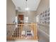 The carpeted second floor hallway has wooden banisters, gray walls and a gallery of photographs at 8929 Monte Oro Dr, Las Vegas, NV 89131