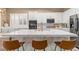 The kitchen features a large marble island with seating and modern appliances, perfect for casual dining and entertaining at 8929 Monte Oro Dr, Las Vegas, NV 89131