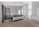The large main bedroom has neutral colors, carpet, a four-poster bed and lots of natural light at 8929 Monte Oro Dr, Las Vegas, NV 89131