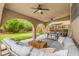Covered patio with outdoor furniture, ceiling fans, and a view of the landscaped backyard at 8929 Monte Oro Dr, Las Vegas, NV 89131