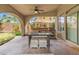 Covered patio with seating, dining area, and built-in barbecue setup overlooking the backyard at 8929 Monte Oro Dr, Las Vegas, NV 89131