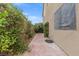 Exterior side yard showing landscape and a hose at 8929 Monte Oro Dr, Las Vegas, NV 89131