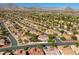 Expansive aerial view of a well-planned community near the mountains, with single-Gathering homes nestled among lush greenery at 9201 Yucca Blossom Dr, Las Vegas, NV 89134
