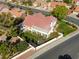 Beautiful aerial view of a home with a well-manicured lawn and mature trees, enclosed by a modern white fence at 9201 Yucca Blossom Dr, Las Vegas, NV 89134