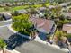 Aerial view of a home with a tile roof, well-manicured landscaping, and a tree-lined street at 9201 Yucca Blossom Dr, Las Vegas, NV 89134