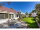 Backyard featuring a tiled roof, covered patio, and manicured lawn with lounge chairs at 9201 Yucca Blossom Dr, Las Vegas, NV 89134