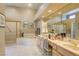 Luxurious bathroom with dual sinks, large mirrors, separate shower, and soaking tub for ultimate relaxation at 9201 Yucca Blossom Dr, Las Vegas, NV 89134