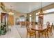 Formal dining room featuring a chandelier, a wooden table, and views into the living room at 9201 Yucca Blossom Dr, Las Vegas, NV 89134