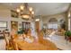 Well-lit dining room with an elegant chandelier and wooden furniture, open to the living area at 9201 Yucca Blossom Dr, Las Vegas, NV 89134