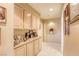 Hallway with neutral walls, tile floor, built-in cabinets, and decoratively framed photos at 9201 Yucca Blossom Dr, Las Vegas, NV 89134