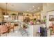 Bright eat-in kitchen features a breakfast bar, granite countertops, ample cabinetry, and a dining area at 9201 Yucca Blossom Dr, Las Vegas, NV 89134