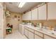 Functional laundry room featuring ample counter space, built-in cabinets, and modern appliances for efficient chores at 9201 Yucca Blossom Dr, Las Vegas, NV 89134