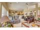Spacious living room with plush seating, open concept, and bright natural light from large windows at 9201 Yucca Blossom Dr, Las Vegas, NV 89134