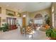 Well-lit living room with plush seating, tile flooring, and access to the dining room at 9201 Yucca Blossom Dr, Las Vegas, NV 89134