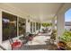Covered patio with outdoor seating offering a view of the lush backyard at 9201 Yucca Blossom Dr, Las Vegas, NV 89134