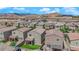 Expansive aerial view of a residential area featuring rows of houses, with mountain views in the distance at 9947 Tucket Point Ct, Las Vegas, NV 89178