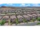 An elevated view of a new construction neighborhood, showing many two story homes, and desert mountains in the distance at 9947 Tucket Point Ct, Las Vegas, NV 89178