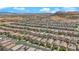 Expansive aerial view of a residential area featuring rows of houses, and desert mountains in the distance at 9947 Tucket Point Ct, Las Vegas, NV 89178