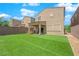 A well-maintained backyard with lush green artificial turf and a covered patio seating area is perfect for entertaining at 9947 Tucket Point Ct, Las Vegas, NV 89178