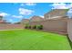 A well-maintained backyard with lush green artificial turf and a brick retaining wall is perfect for outdoor activities at 9947 Tucket Point Ct, Las Vegas, NV 89178