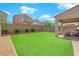 Beautiful backyard featuring lush green grass and a covered patio with comfortable seating at 9947 Tucket Point Ct, Las Vegas, NV 89178