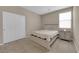 Comfortable bedroom with carpet, closet, nightstand and window at 9947 Tucket Point Ct, Las Vegas, NV 89178