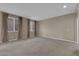 A spacious bedroom with neutral walls, plush carpet, and large windows at 9947 Tucket Point Ct, Las Vegas, NV 89178