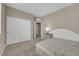 Bright bedroom with sliding closet doors, carpet, and a nightstand at 9947 Tucket Point Ct, Las Vegas, NV 89178