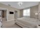 Spacious bedroom featuring neutral decor, carpeted floor, and large window with sheer curtains at 9947 Tucket Point Ct, Las Vegas, NV 89178