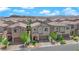 View of this two story home, with desert landscaping, brick driveway, and a two car garage at 9947 Tucket Point Ct, Las Vegas, NV 89178