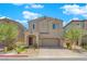 Two-story home featuring neutral stucco, tiled roof, manicured lawn, and paver driveway at 9947 Tucket Point Ct, Las Vegas, NV 89178