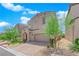 Two-story home with neutral stucco, paver driveway, and desert landscaping at 9947 Tucket Point Ct, Las Vegas, NV 89178