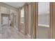 Inviting hallway featuring neutral walls, wood-look floors, and natural light at 9947 Tucket Point Ct, Las Vegas, NV 89178