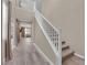 Inviting hallway with wood-look floors, staircase, and views into adjacent living spaces at 9947 Tucket Point Ct, Las Vegas, NV 89178