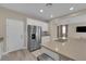 Spacious kitchen island with stainless steel refrigerator and white cabinets at 9947 Tucket Point Ct, Las Vegas, NV 89178
