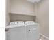 Well-lit laundry room featuring a modern, white washer and dryer with an overhead shelf at 9947 Tucket Point Ct, Las Vegas, NV 89178