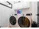 Clean laundry room featuring modern washer and dryer units and overhead cabinets for storage at 11134 Casala Ct, Las Vegas, NV 89141