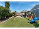 Inviting backyard featuring artificial turf, a covered patio, outdoor furniture and a playground at 2093 Seahurst Dr, Las Vegas, NV 89142