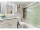 Bathroom with marble walls, granite countertops, glass shower doors, and white cabinets offers sleek modern design at 2093 Seahurst Dr, Las Vegas, NV 89142