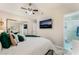 Serene bedroom with a TV, a ceiling fan and an ensuite bathroom at 2093 Seahurst Dr, Las Vegas, NV 89142