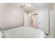 Bedroom with light walls, ceiling fan, and closet with a bed that has mint green covers at 2093 Seahurst Dr, Las Vegas, NV 89142