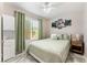 Bright bedroom features a ceiling fan, large window, and stylish décor for a comfortable and inviting space at 2093 Seahurst Dr, Las Vegas, NV 89142