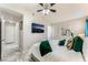 Cozy bedroom with a ceiling fan, a television, and a comfortable bed at 2093 Seahurst Dr, Las Vegas, NV 89142
