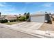 Charming single-story home featuring a well-manicured lawn, mature trees, and a two-car garage at 2093 Seahurst Dr, Las Vegas, NV 89142