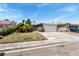 Charming single-story home featuring a well-manicured lawn, mature trees, and a two-car garage at 2093 Seahurst Dr, Las Vegas, NV 89142