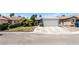 Charming single-story home featuring a well-manicured lawn, mature trees, and a two-car garage at 2093 Seahurst Dr, Las Vegas, NV 89142