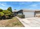 Charming single story home featuring a 2 car garage, well-manicured bushes, and desert landscaping at 2093 Seahurst Dr, Las Vegas, NV 89142