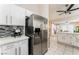 An updated kitchen featuring stainless steel appliances and view into dining and living areas at 2093 Seahurst Dr, Las Vegas, NV 89142